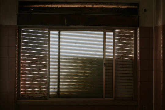 Light filtering through closed window blinds