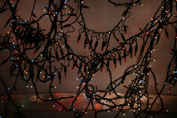 Tangled colorful festive lights hanging indoors