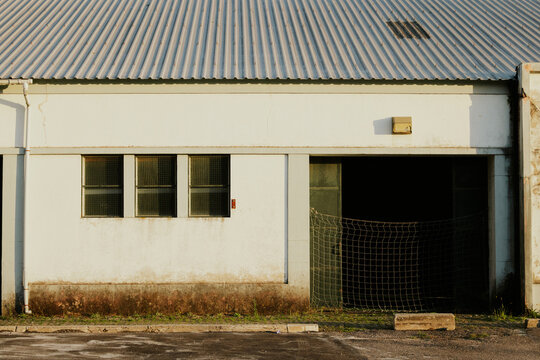 Abandoned warehouse exterior under warm sunlight