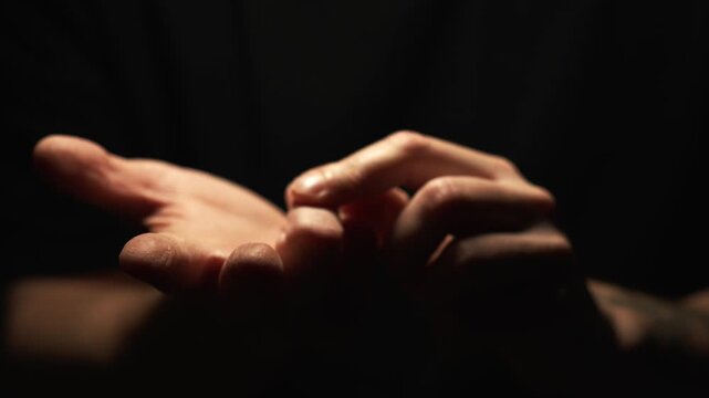 Listing options and bending fingers.
Presenting arguments in a dialogue.
A man clenches his fingers into a fist.