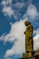 Edinburgh, Scotland: one of the moss covered statues in the Greyfriars Kirkyard, the graveyard surrounding Greyfriars Kirk in the Old Town, where burials have started since the late 16th century