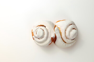 Fragrant Cinnabons with cream on a white background. Insulation