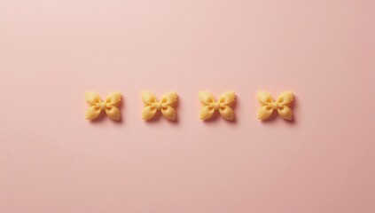Line of raw farfalle pasta on pink background highlighting pasta shape and home cooking process