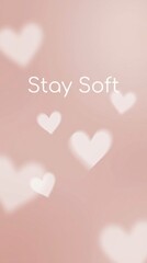 Delicate pink hearts with stay soft text, emotional warmth, gentle minimalist phone wallpaper.