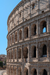 Fototapeta premium Italy - Rome - Colosseum - Iconic stone arches and ancient Roman architecture on the famous exterior wall of the massive stone structure