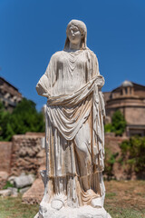 Fototapeta premium Italy - Rome - House of Vestal Virgins - Ancient marble statue of a priestess in draped robes in the Roman Forum archaeological site.
