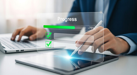 A businessman in a suit interacts with a digital tablet and laptop displaying a progress bar.