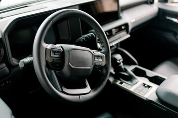Naklejka premium Modern Car Interior Showing Steering Wheel, Dashboard, and Leather Seats