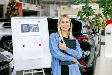 Saleswoman showing infographic during presentation about automotive suspension performance in car dealership