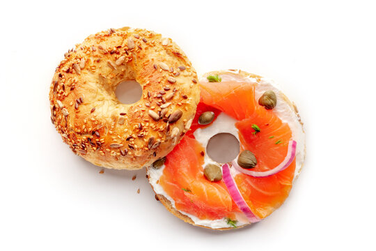 Lox, smoked salmon, bagel, with cream cheese and onion, and capers, and dill, on a white background, isolated, overhead flat lay shot