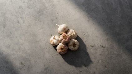 Garlic cloves arranged on a gray background for food preparation, storage and handling