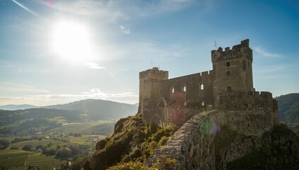 Castle perspective in the Vaucluse with ancient stone structures under a clear blue sky, urban exploration, preservation