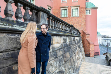 Couple enjoys a moment together near historic buildings in a city in winter