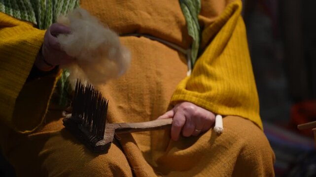 Artisan Woman&rsquo;s Hands Expertly Carding Raw Wool to Prepare Soft Rolags for Traditional Hand Knitting