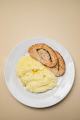 Delicious sliced chicken roll with spinach and cheese and mashed potatos