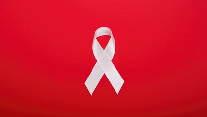 Red background with white lung cancer awareness ribbon and lung symbol, highlighting health initiative during Lung Cancer Awareness Month