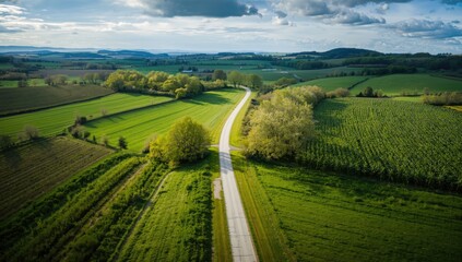 Bird's-eye perspective of rural road amid farmland, ideal for editorial header backgrounds