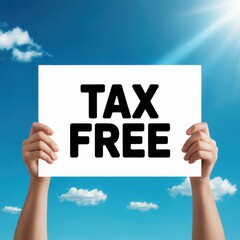 Two hands holding a white sign with black text T A X F R E against a bright blue sky