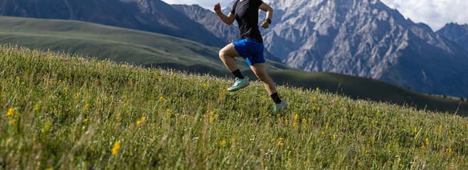 Woman runner running on the beautiful flowering grassland mountain top