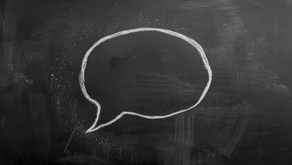 Chalk-drawn speech bubble on a dark background, facilitating visual communication in teaching environments