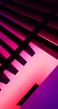 A multicolored light structure with wooden railings at night, concept artsy architecture shot