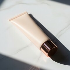 Elegant cosmetic tube with rose gold cap lying on a white marble surface in bright light