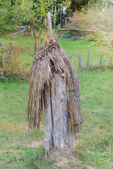 Old authentic beehive. History of beekeeping. Beehives near authentic housing.