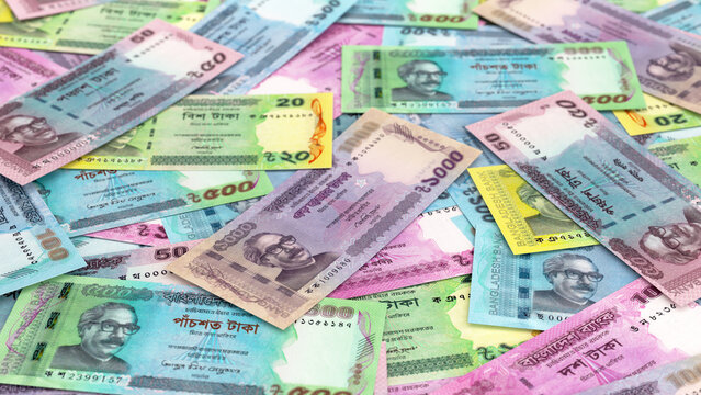 Scattered Bangladeshi Taka banknotes background.
