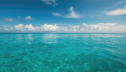 Obraz premium Clear sky with soft white clouds over calm water, suitable for editorial header background, Earth Day