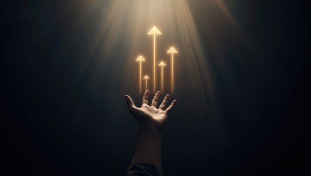 Persons hand extended toward rising arrows amidst subdued lighting, indicating progress and upward movement