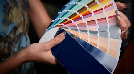 Color palette guide in female hands, color chart choosing
