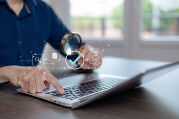 Business verification and data review concept with magnifying glass and check mark on laptop. Digital search, audit, compliance, security validation, and quality control for online systems and modern 