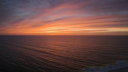 Aerial drone shot of a vibrant sunrise illuminating the Gulf of Mexico at Padre Island, Texas, seasonal change