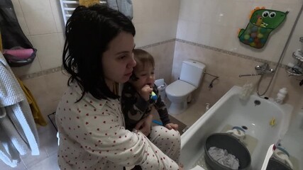Mother and Child Brushing Teeth Together