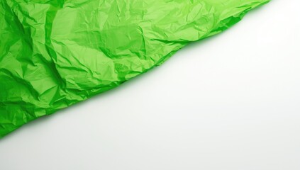Bright green textured paper crumpled on a white backdrop functions as an artistic background for visual compositions, Earth Day