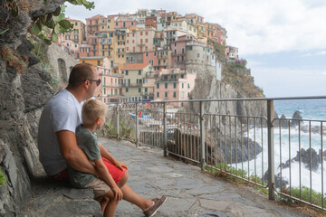 Fototapeta premium Father and Son Overlooking Coastal Town