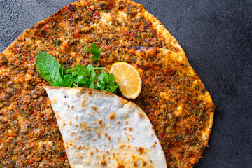 Big size lahmacun on black stone background