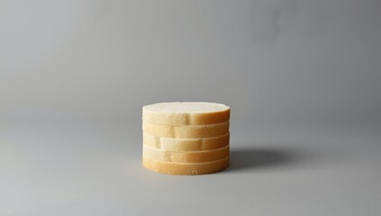 Layered slices of white bread arranged horizontally on gray surface, serving as a background for editorial or graphic design
