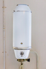 Old Dutch kitchen gas water heater on a weathered wall