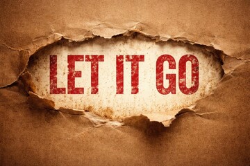 Let it go phrase in worn red lettering visible through ripped brown craft paper with artistic grain