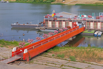 Red Gangway Ramp to Floating Pontoon and Boat Dock at River Tisza in Szeged Hungary © markobe