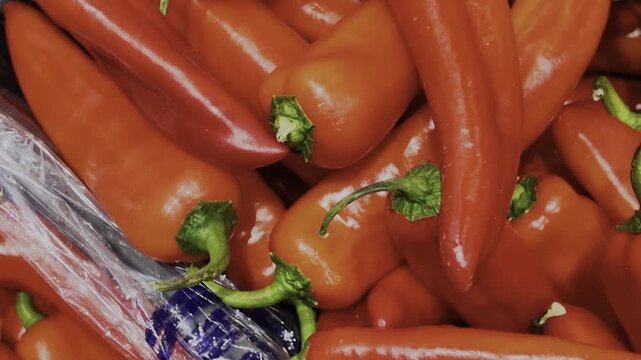 Crates filled with sweet red peppers in a supermarket sales area. 