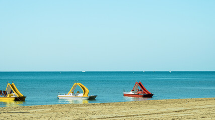 three pedal boats on the beach, Bibione Pineda, Venice, Italy