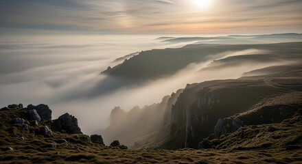 A scenic vista showcasing rugged cliffs emerging from a sea of clouds, illuminated by the warm glow of the setting sun