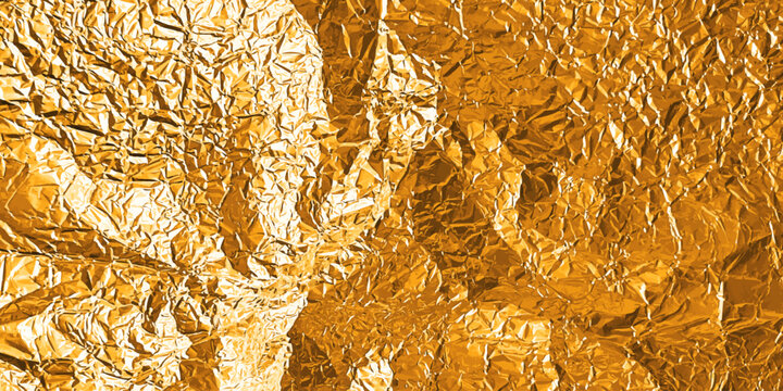 Gold foil texture with glossy crumpled surface - golden metallic background with wrinkled paper grain pattern. Shiny bronze material with rough folds and luxury sheen for premium elegant design.