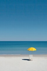 Fototapeta premium Empty Beach Scene With Yellow Umbrella And White Chair