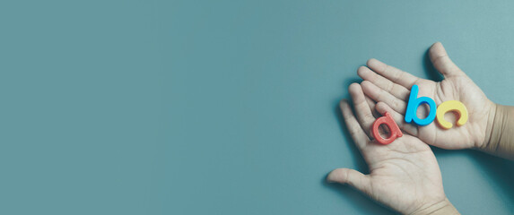 Child Hands Holding Colorful ABC Letters for Early Childhood Literacy and Education