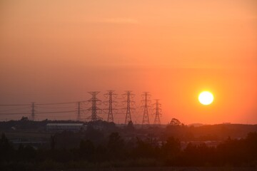 high voltage electric pole on twilight sunset sky in evening
