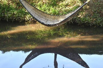 close up of bamboo litter hanging on canal for sitting and relaxing in garden