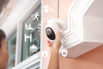 Home Security and Family Safety Concept, Asian Woman setting IP Camera with AI Smart Home System,...